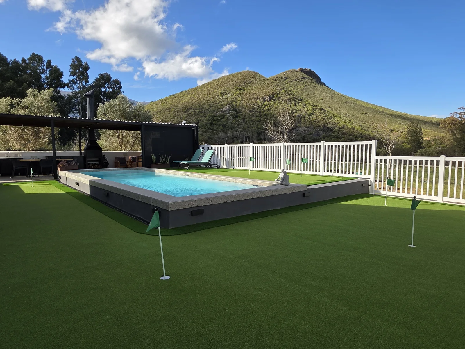 Strings swimming pool and outdoor leisure area with mountain views